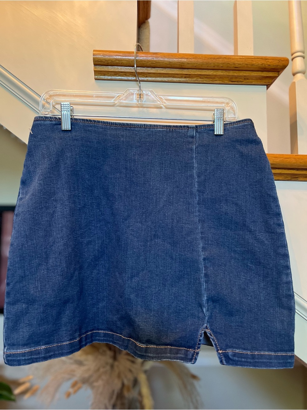 Blue Denim Mini Skirt featuring a medium/dark blue wash